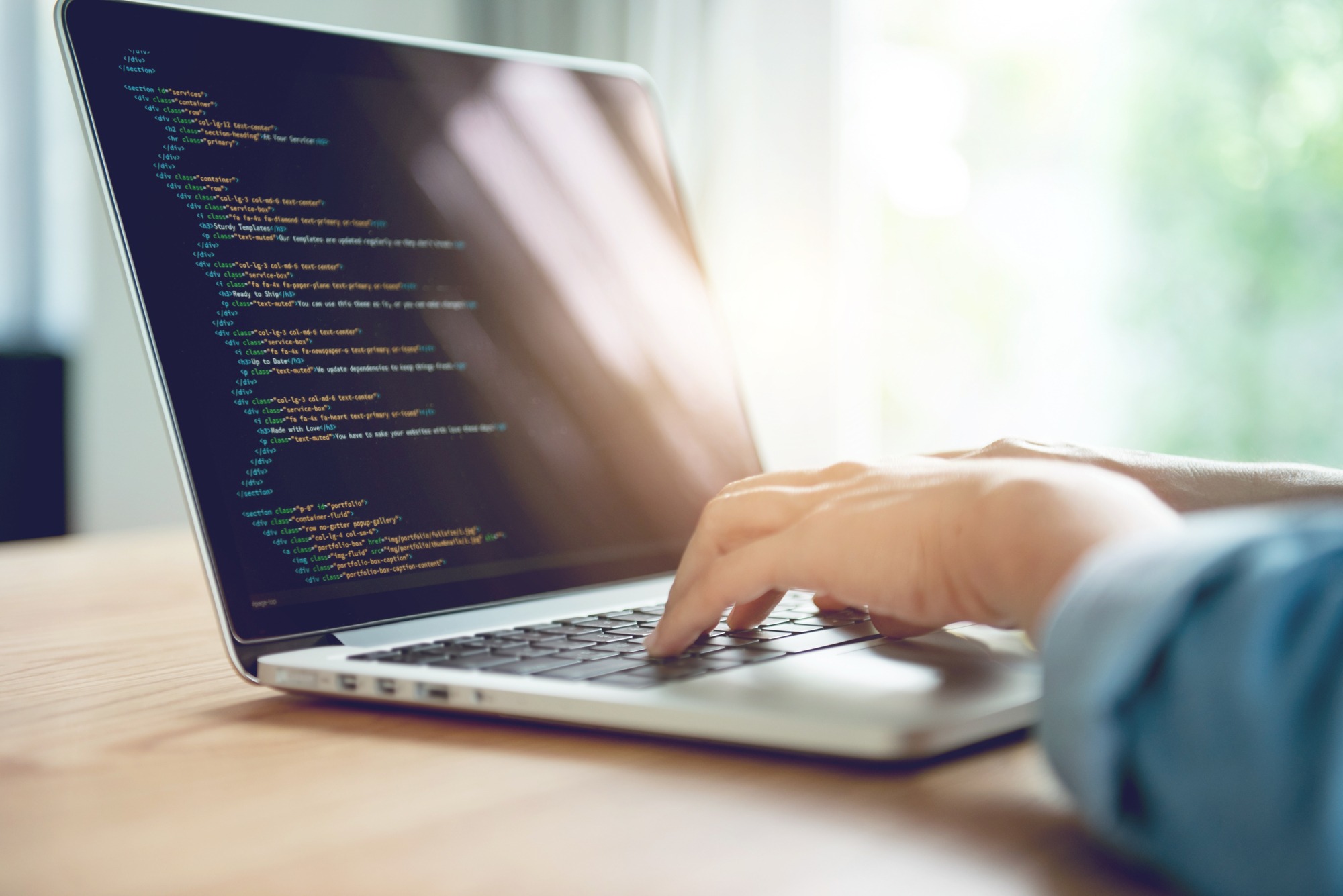 Close up Woman hands coding html and programming on screen laptop